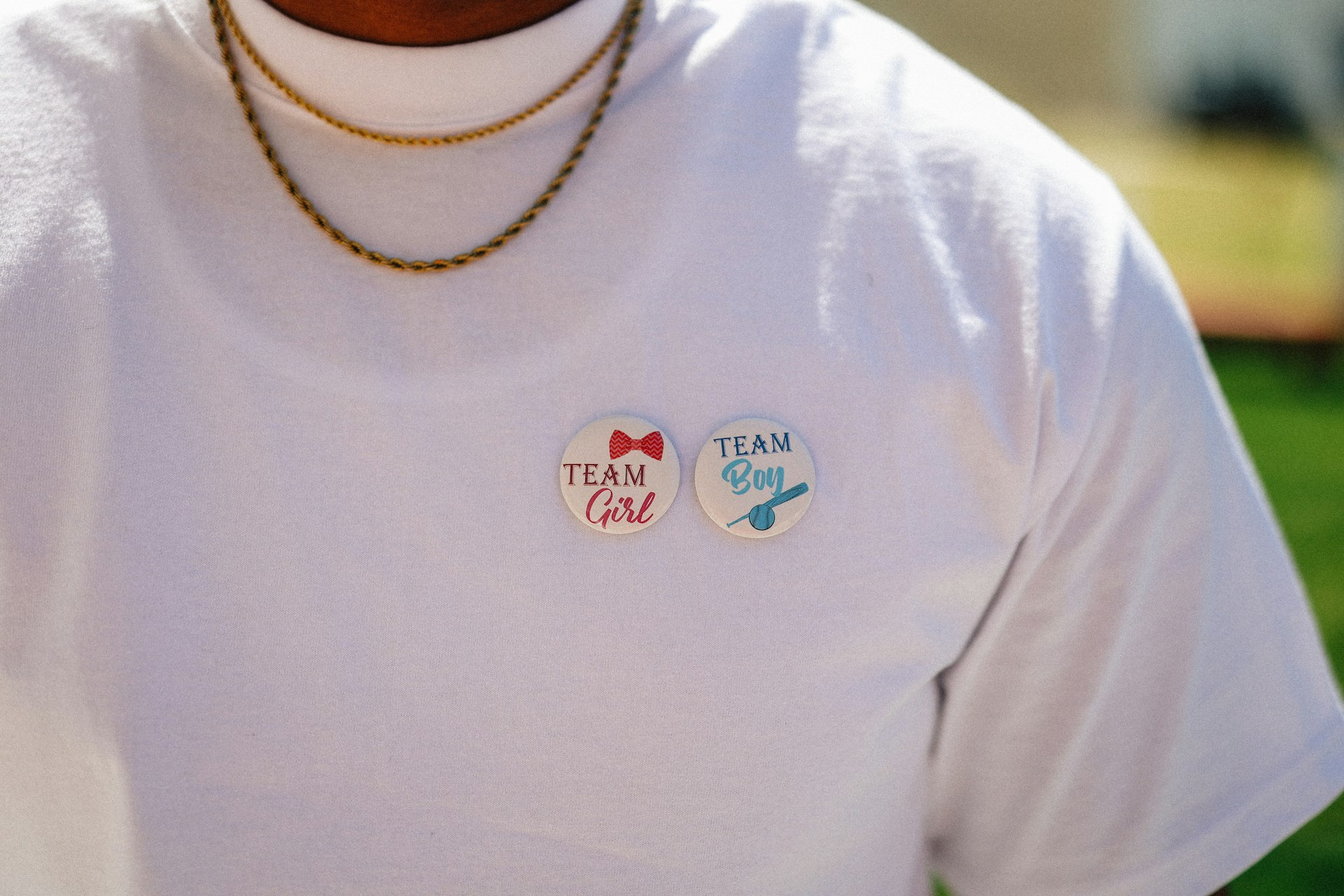 The shirt shows "team girl" and "team boy" buttons.